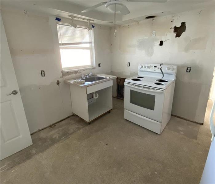 empty kitchen, no cabinets, just oven