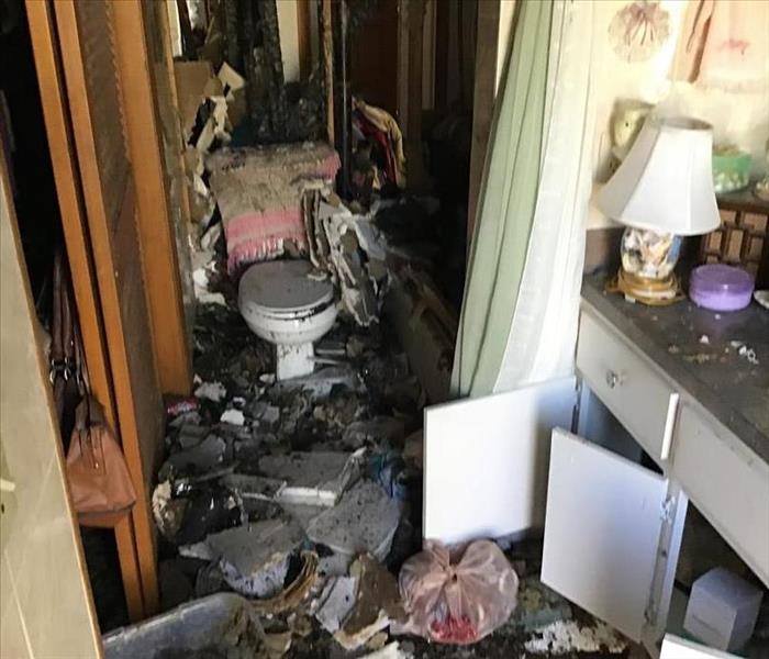 Ceiling debri all over toilet and bathroom from fire