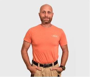 Male standing in front of a light background.